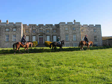 Three riders in front of Hazelwood Castle